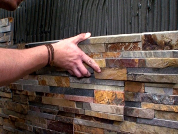 Thin stone veneer panel system units being installed on a wall using thinset